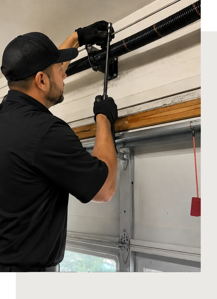 Garage Door Spring Repair Technician Working on Torsion Spring
